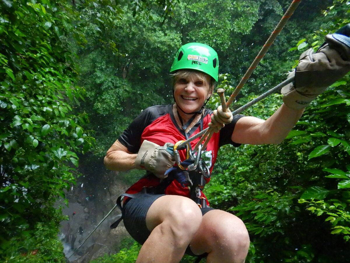 Susan P., MyGevity member, zip-lining through a rainforest
